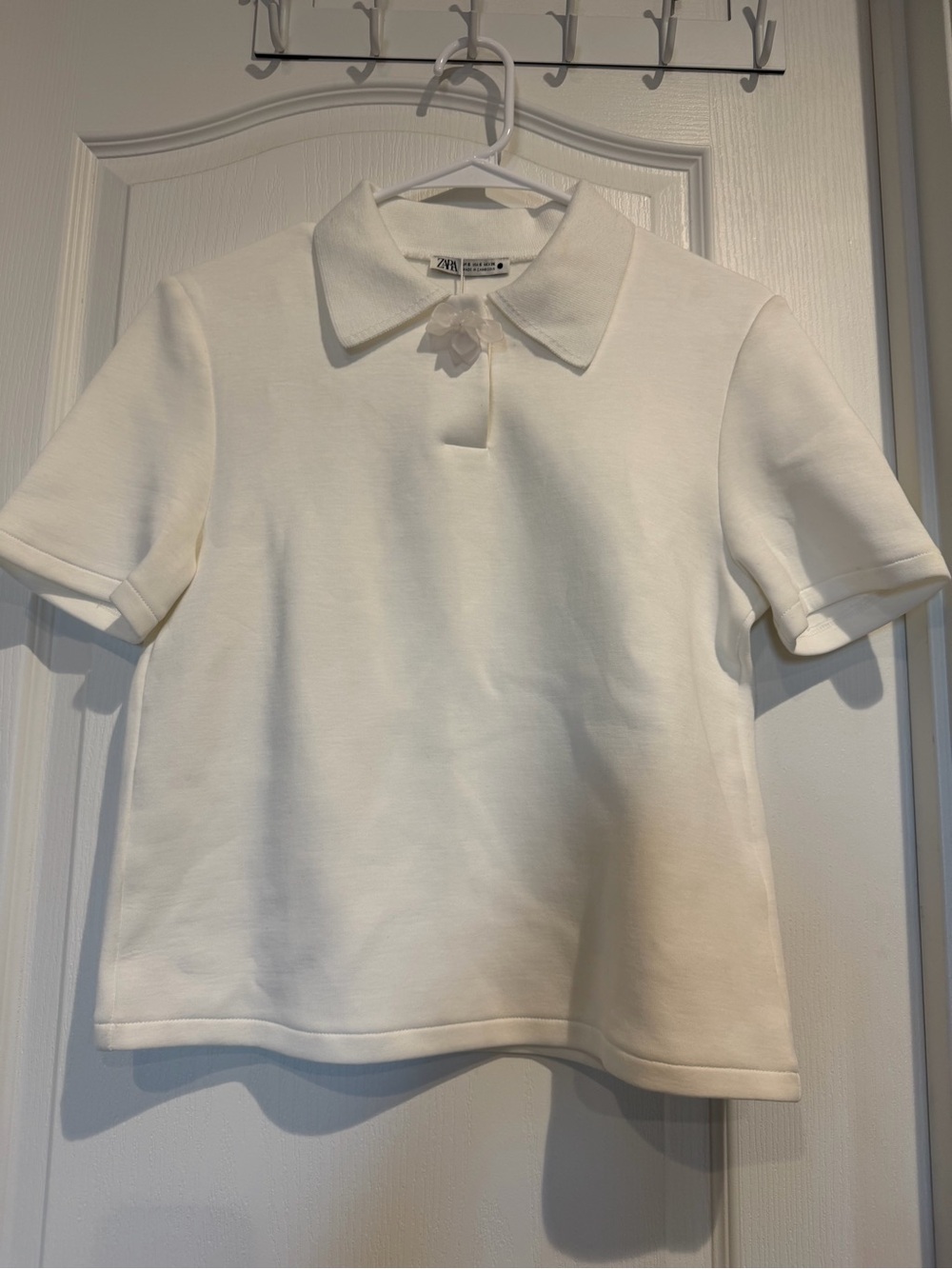 Women’s White Short-Sleeve Polo Top with Flower Accent